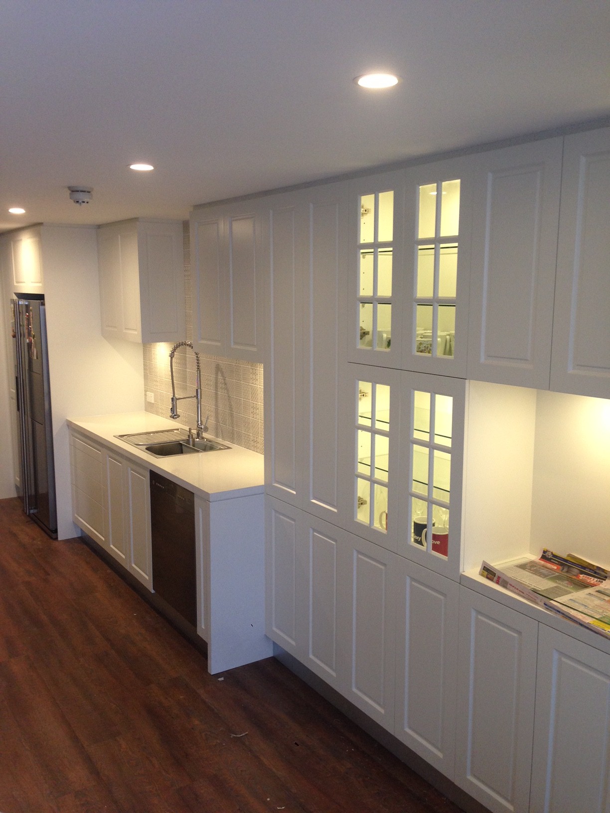 Line of cabinets connected to white kitchen